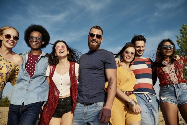 Young smiling people in a row on the fresh air